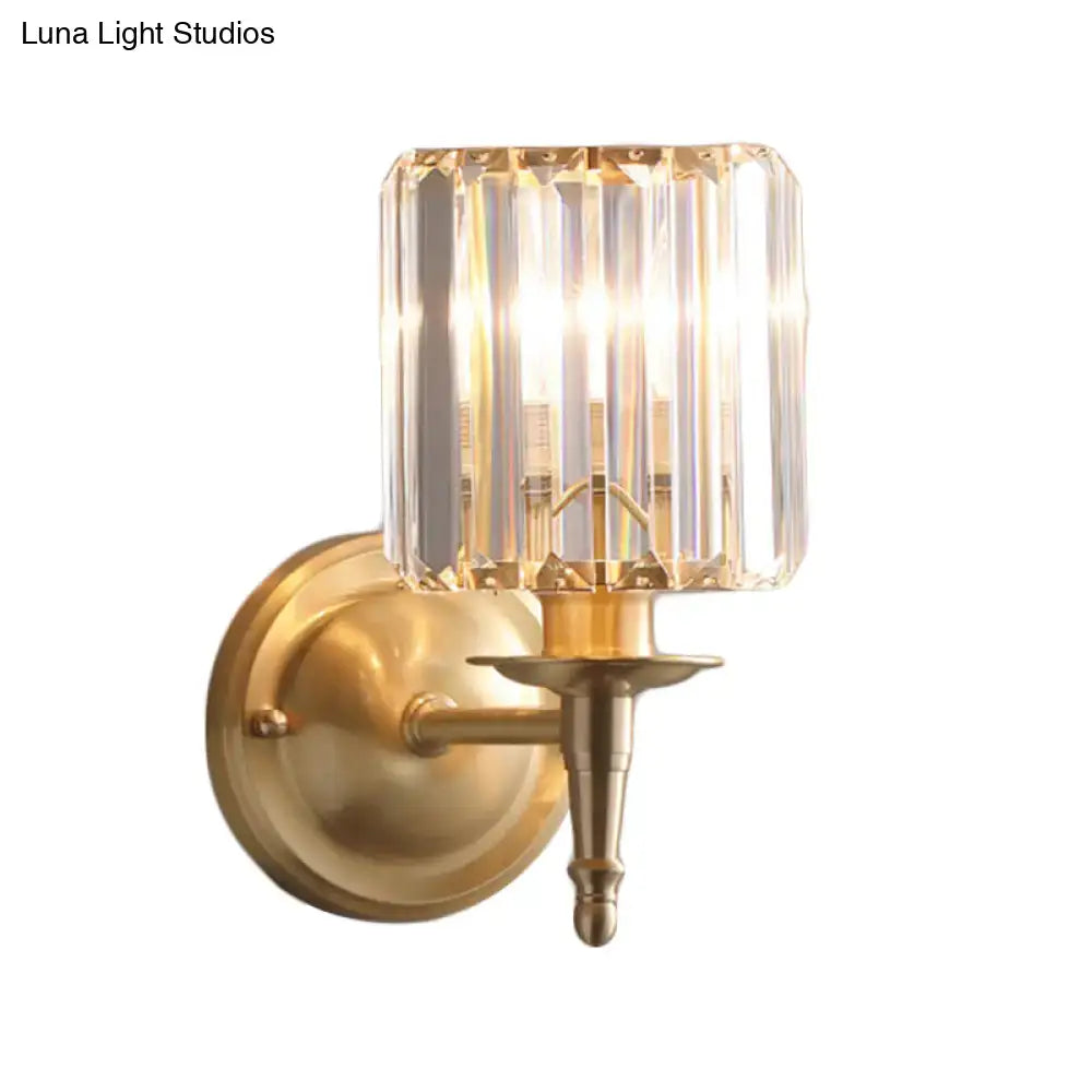 Modern brass wall light sconce with faceted crystal shade for bedroom illumination and elegant decor