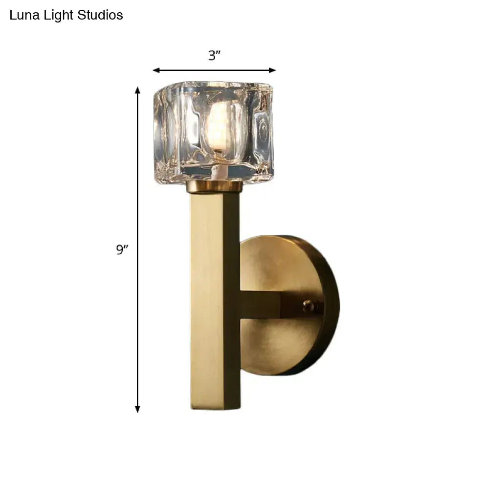 Modern brass wall light with clear crystal block and faceted clear glass shade for living room lighting