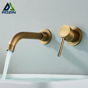Modern brass wall mount basin faucet with a curved spout and cylindrical handle for bathroom use