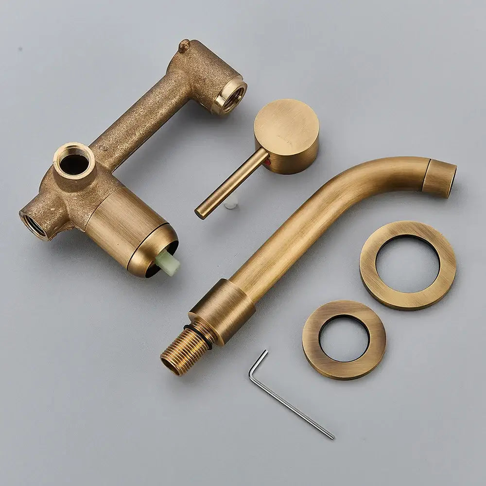 Antique brass-finished modern brass wall mount basin faucet with curved spout and separate handle for bathroom use