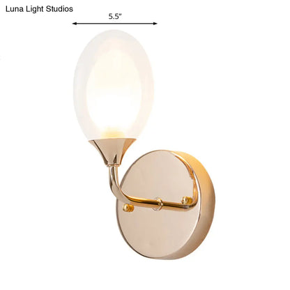 DecorBites™ DecorBites™ Modern Brass Wall Sconce with Clear Glass Shade - Oval Design for Dining Room