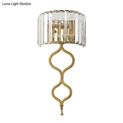 Modern brass wall sconce with crystal rectangle shade and gold-toned cascading design great choice for wall mount lighting