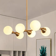 Modern brass-finished bubble island light fixture with five white bubble frosted glass globe shades by decorbites