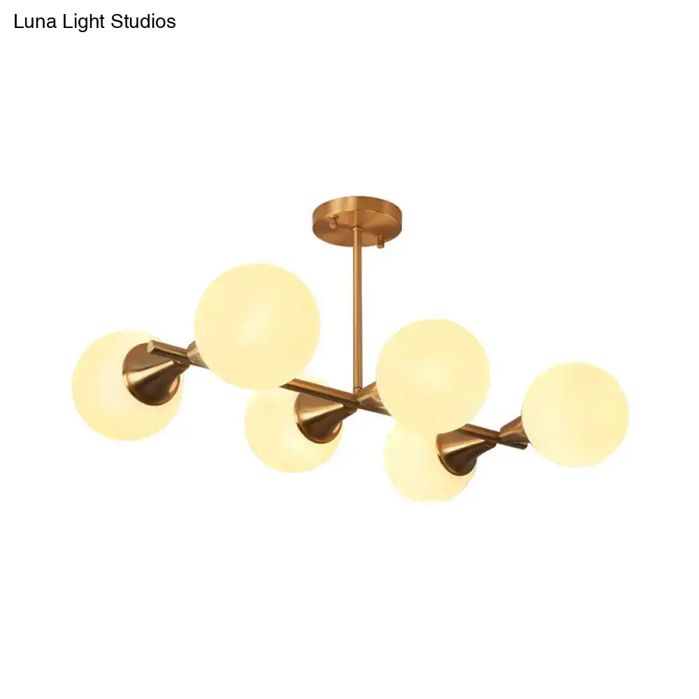 Brass-finished DecorBites clear white bubble island light fixture with six frosted glass globes in modern design
