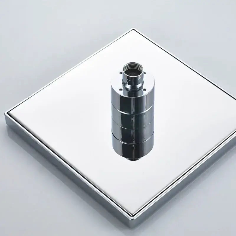 Modern bright chrome led rainfall shower head with a square chrome-finished shower base and central cylindrical drain assembly
