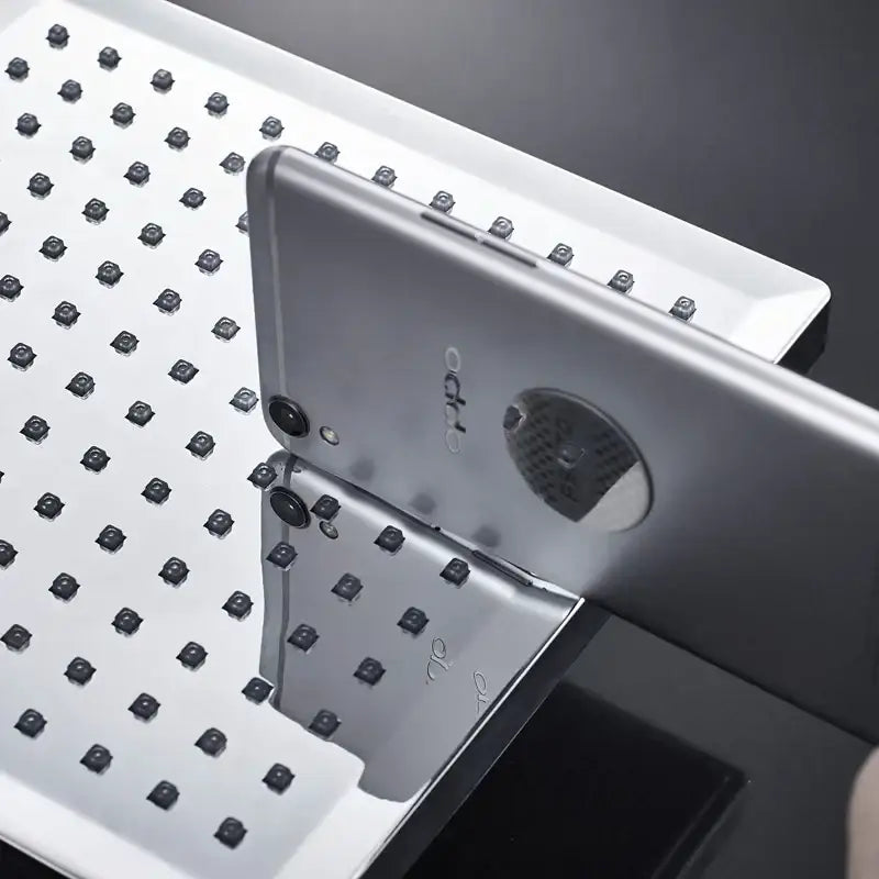 Silver oppo smartphone back side with circular camera module and metallic finish alongside decorbites bright chrome led shower head
