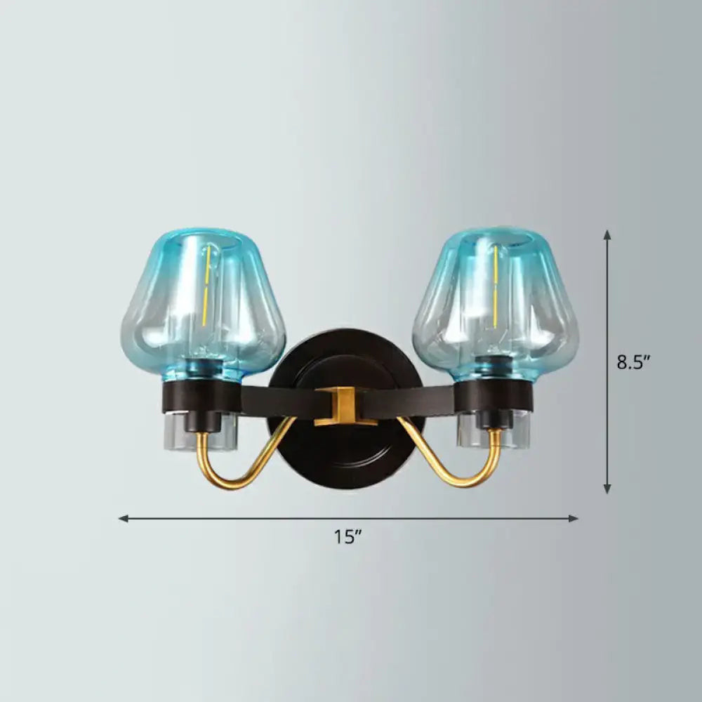 Blue-tinted glass modern bronze and brass smoke gray wall lamp with gold and black metal arms for porch lighting