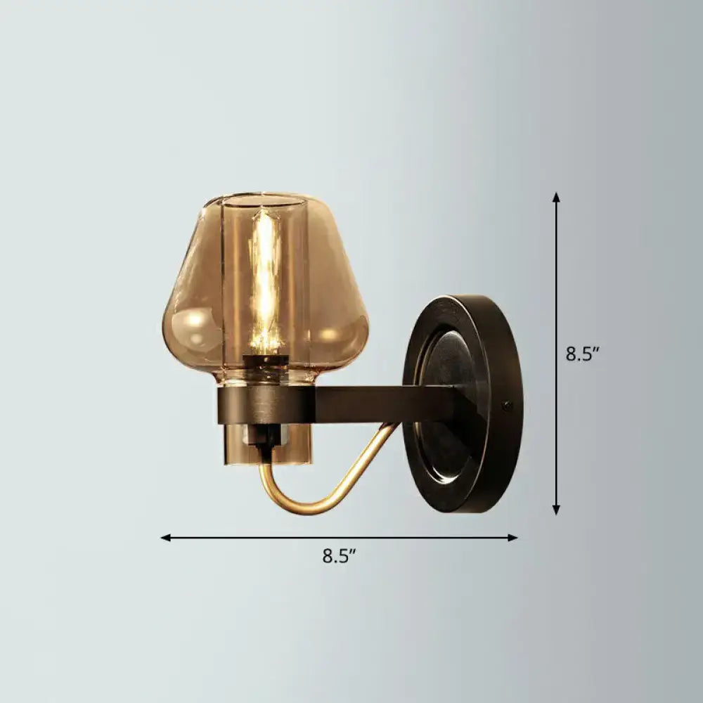 Modern bronze and brass smoke gray wall lamp with a bronze finish, smoked glass shade, and brass accent arm for porch lighting