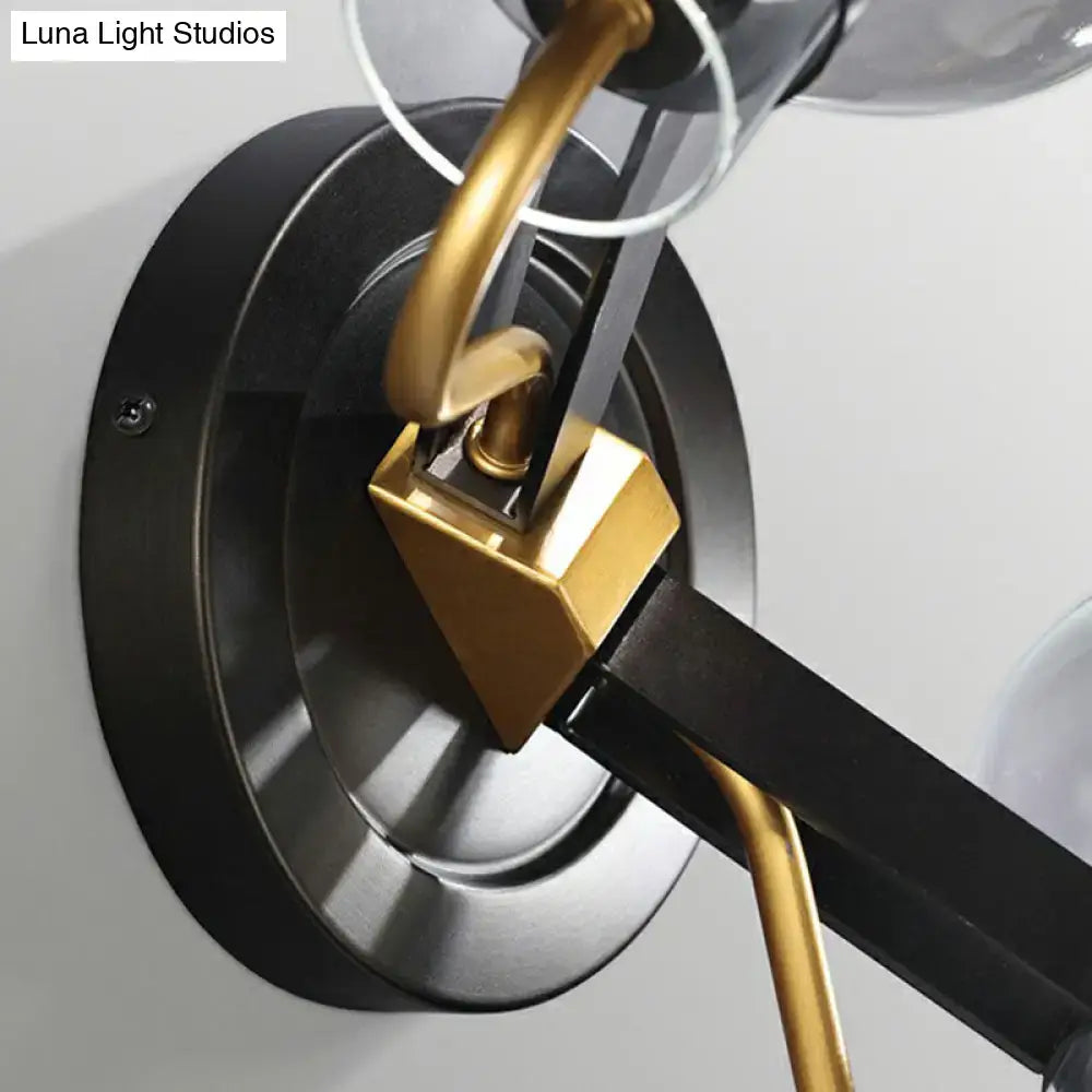 Modern bronze and brass smoke gray wall lamp with sleek black metal base and clear glass shades for led incandescent use