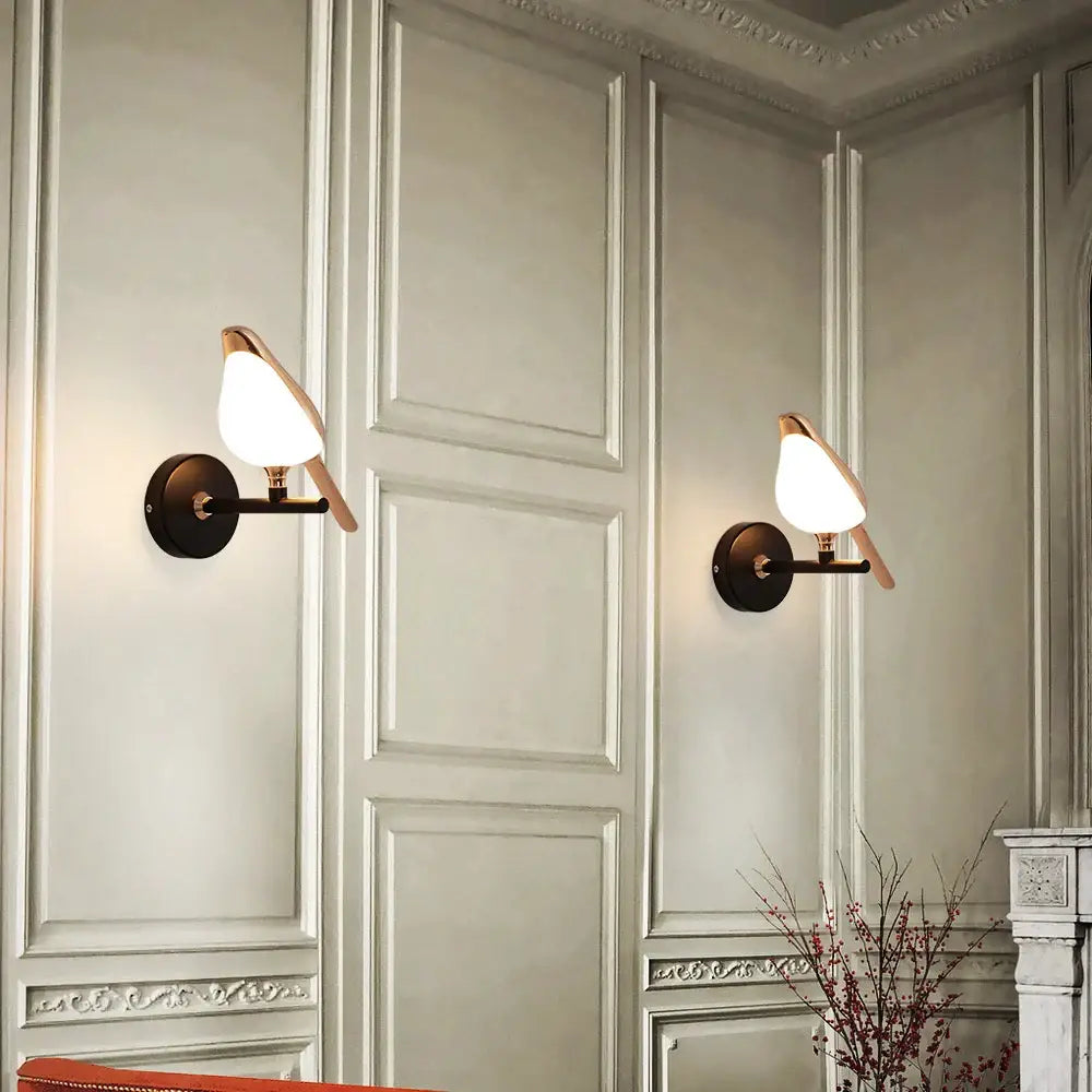 Pair of modern bronze bird wall lights with warm-toned glass shades perfect for living room decorbites bird wall light