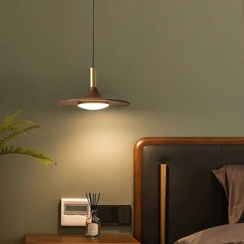 Modern bronze black walnut ufo pendant light with warm circular shade and brass accents for dining room decorbites black walnut