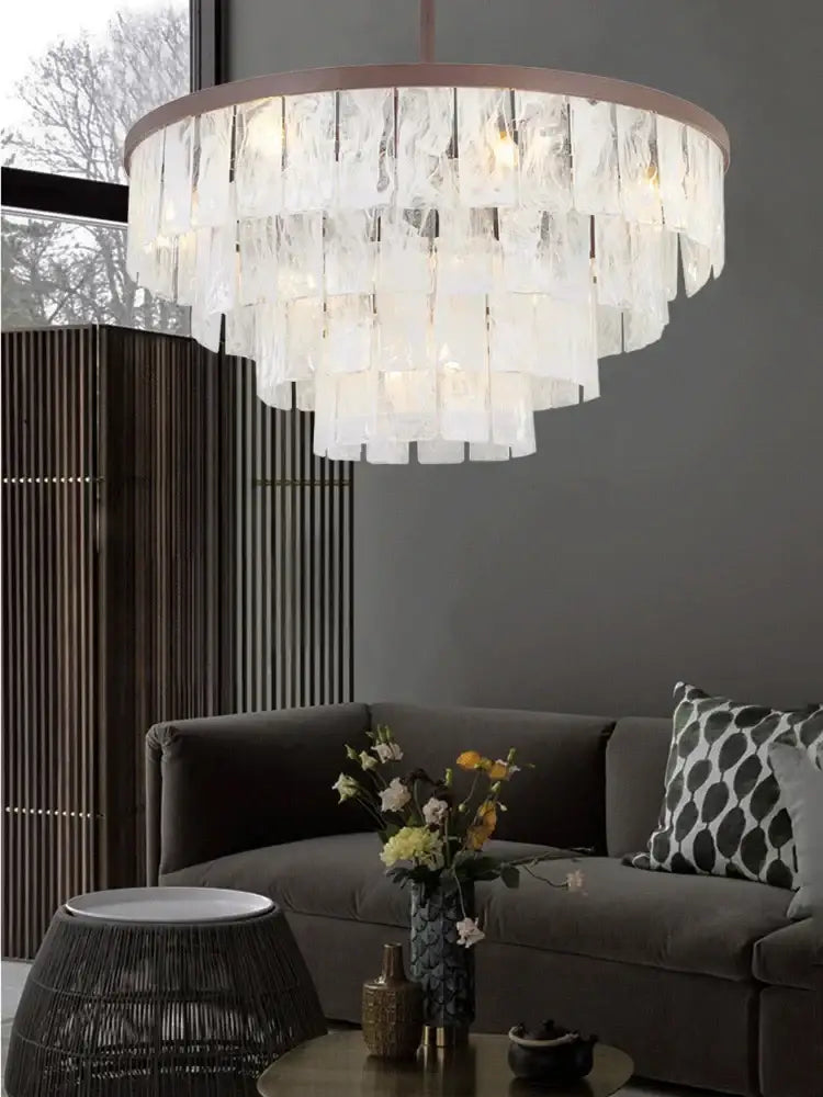 A modern bronze decorbites cloud glass led pendant light with multi-tiered translucent textured glass panels for living room decor