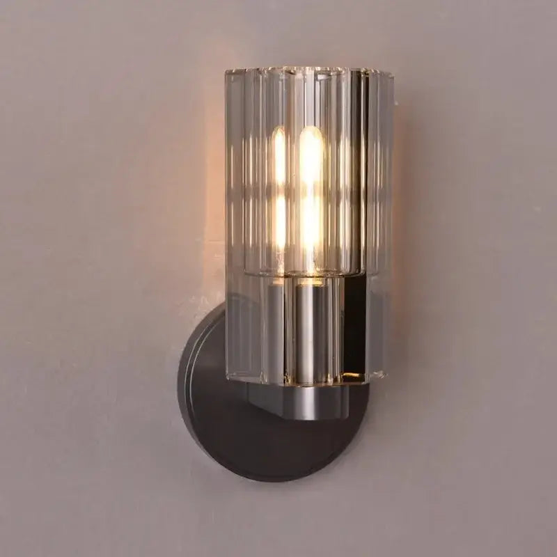 Modern bronze copper crystal wall lamp with a cylindrical glass shade and brushed metal base for bedroom wall lamps decorbites bronze copper