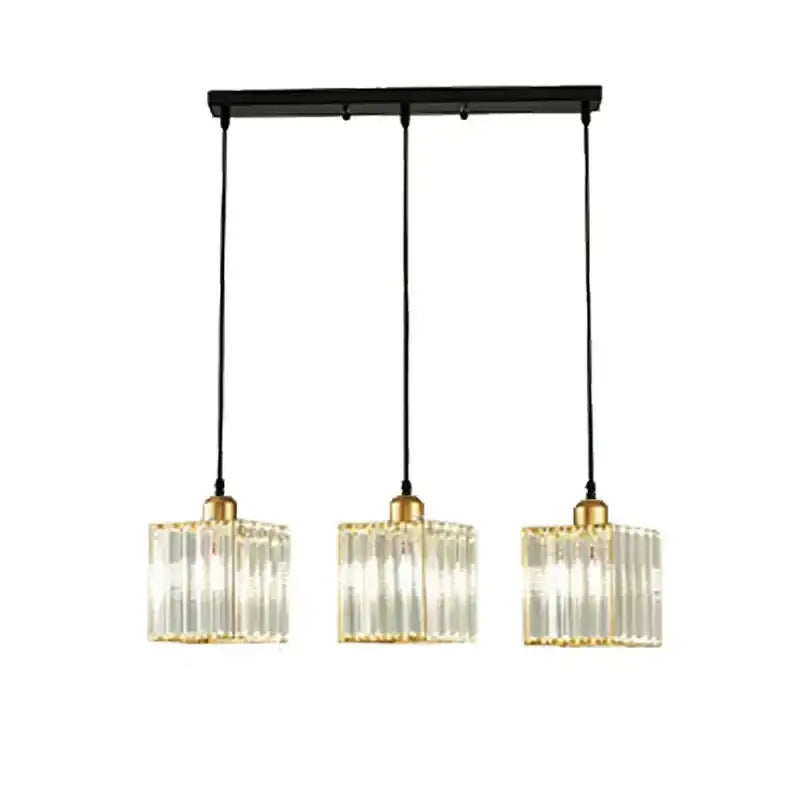 Modern bronze crystal trio pendant light with clear vertically ribbed glass shades and gold-toned metal accents for dining room decorbites crystal trio pendant