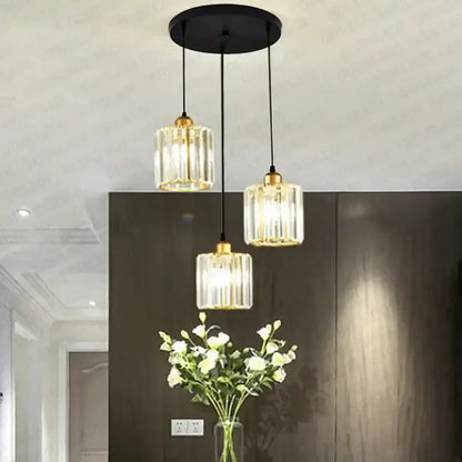 Modern bronze crystal trio pendant light with three glass bulbs gold-toned accents black cords for dining room decorbites crystal trio