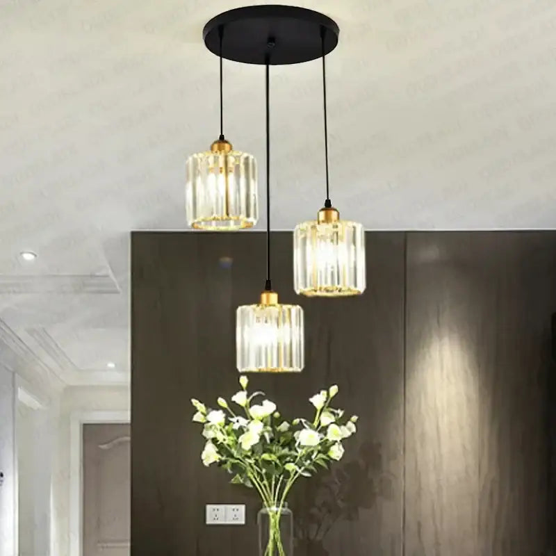 Modern bronze crystal trio pendant light with three glass bulbs gold-toned accents black cords for dining room decorbites crystal trio
