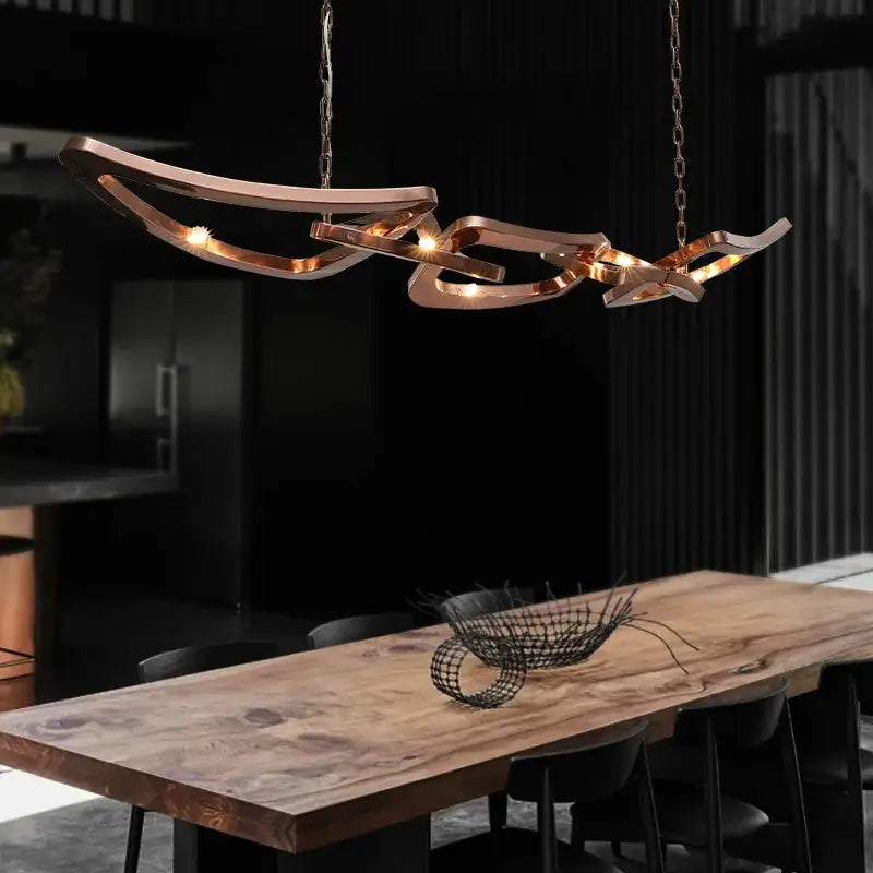 Modern bronze geometric art pendant chandelier with copper-toned metallic curves and warm led bulbs for dining room decorbites art pendant