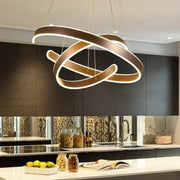 Modern bronze geometric ring pendant light fixture with sleek intertwined rings and glowing white illumination for dining room