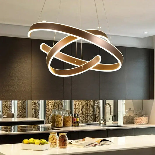 Modern bronze geometric ring pendant light fixture with sleek intertwined rings and glowing white illumination for dining room