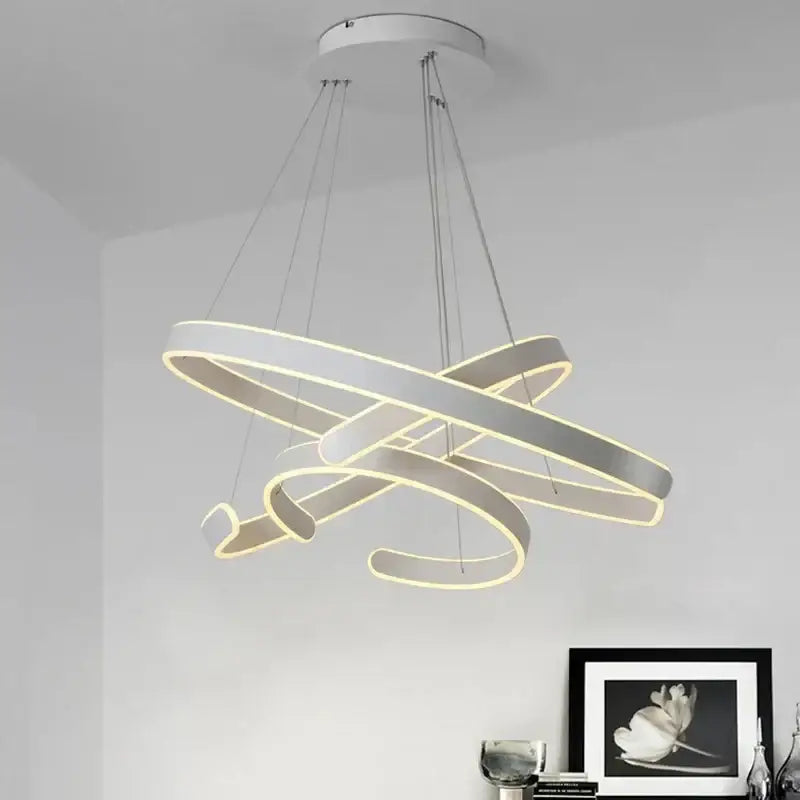 Modern white LED pendant light with interlocking bronze geometry circle rings and warm glow for living room