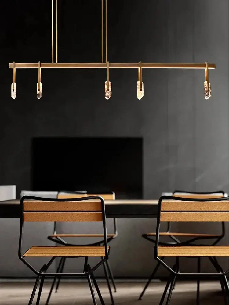 Modern bronze led crystal hanging lamp featuring gold-toned linear pendant light with five crystal-like pendants decorbites bronze led