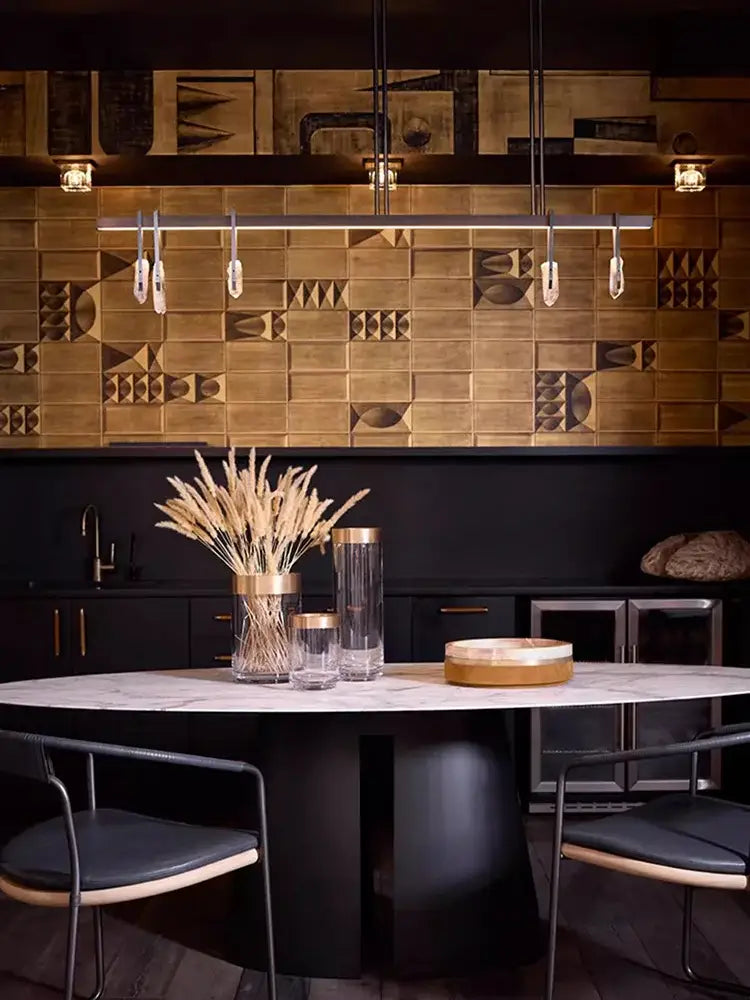 A modern bronze led crystal hanging lamp features a tall glass vase with a gold rim holding dried wheat stalks decorbites bronze led