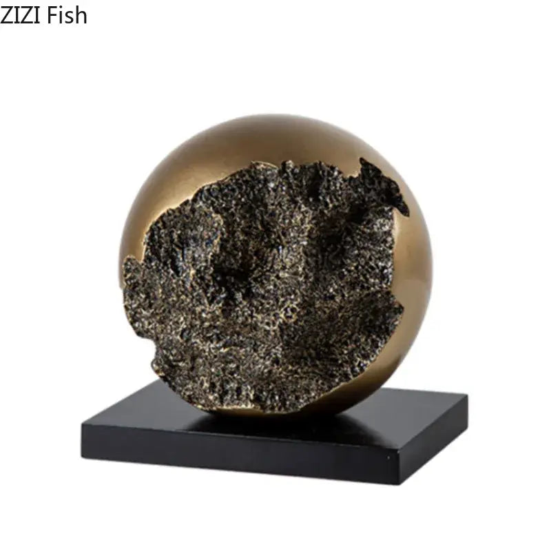 Modern bronze sphere sculpture desk ornament with gold-toned exterior and textured dark interior for living room decor