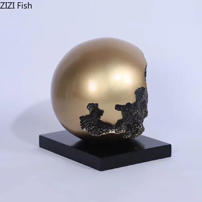 Modern bronze sphere sculpture desk ornament featuring a golden skull with black textured cracks on a black base decorbites bronze sphere