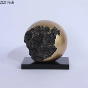 Modern bronze sphere sculpture desk ornament with cracked black textured surface on sleek black base for living room decorbites bronze sphere decor