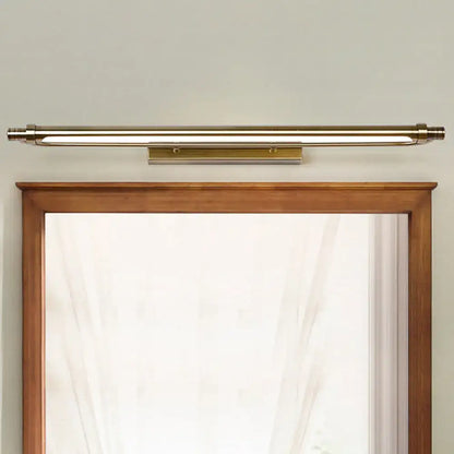 Brass-finished tubed vanity light fixture with sleek modern design providing warm white lighting for bathrooms