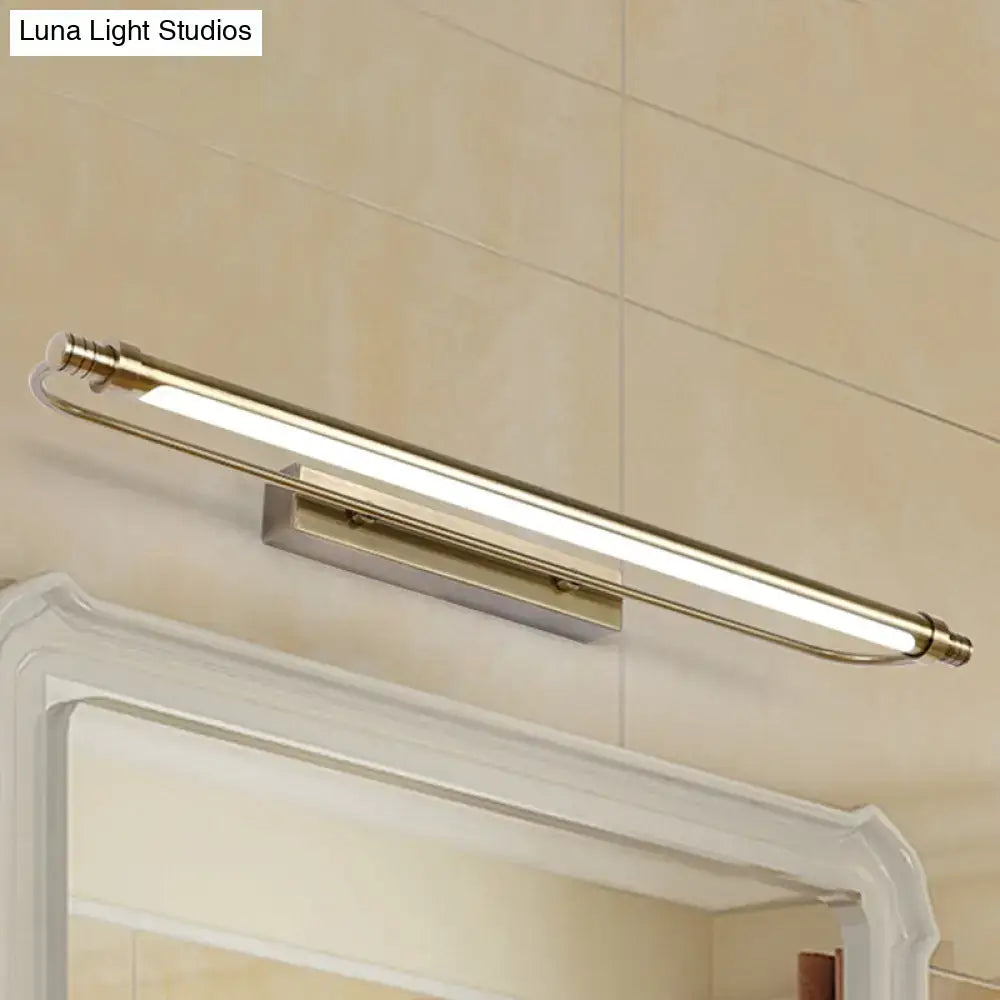 Modern bronze tubed vanity light fixture with brass finish and frosted glass diffuser providing warm white lighting