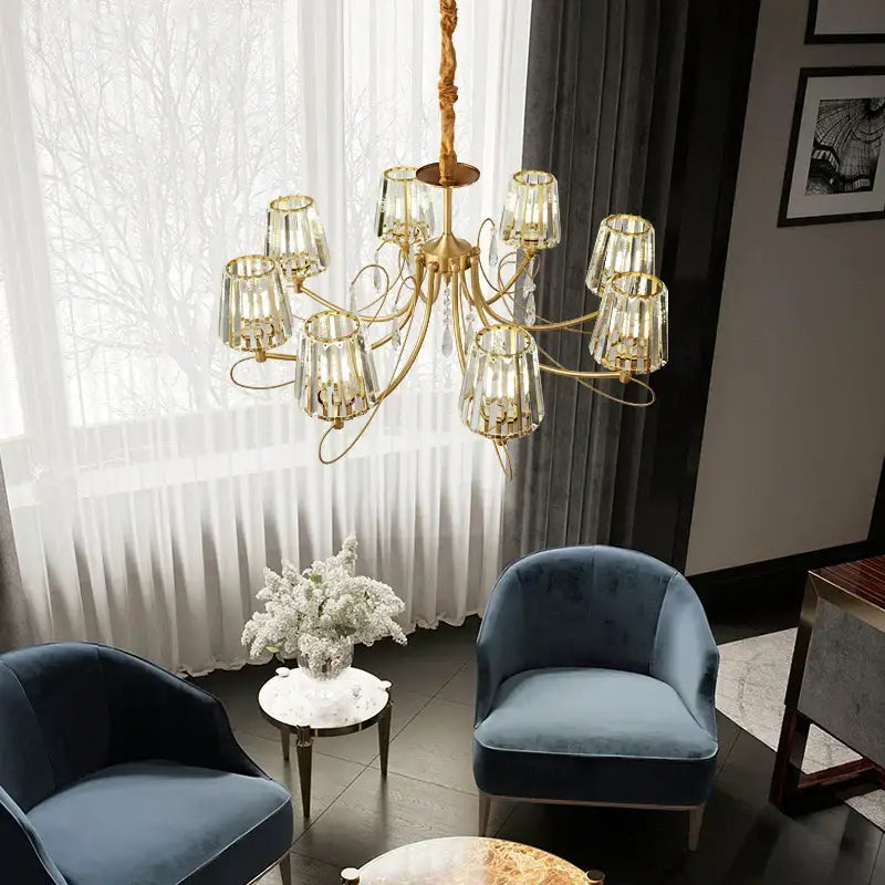 Gold-toned modern light luxury copper chandelier with clear faceted glass shades and crystal accents for bronze villa living room