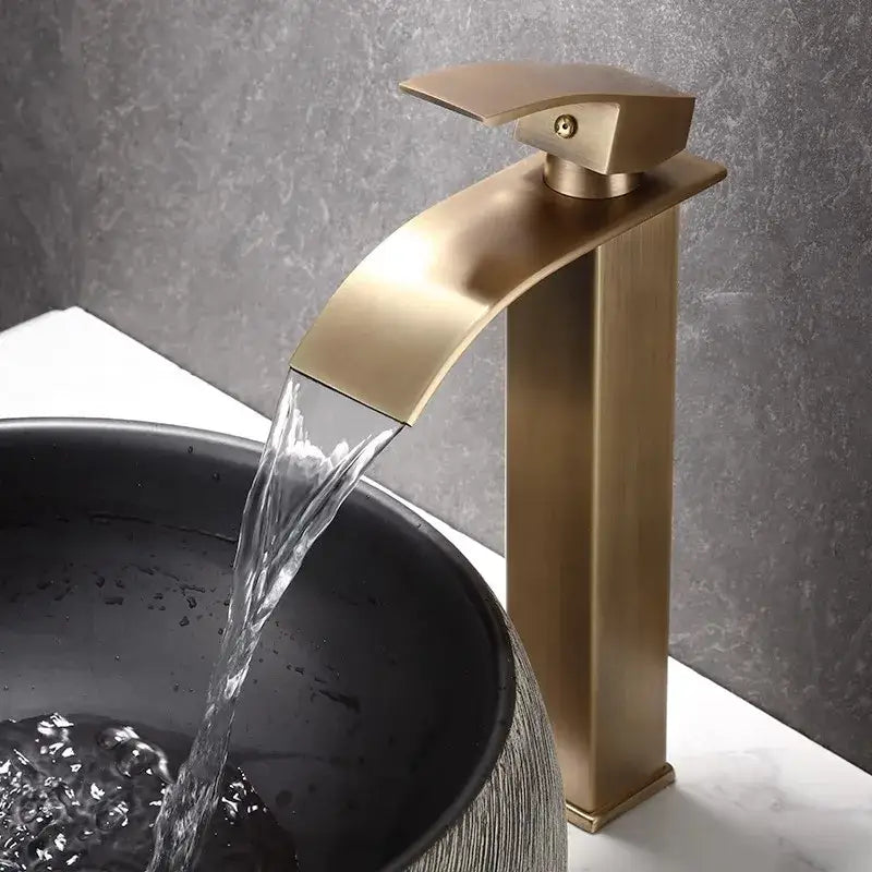 Modern bronze waterfall basin faucet with sleek rectangular spout flowing water into dark basin decorbites bronze basin faucet