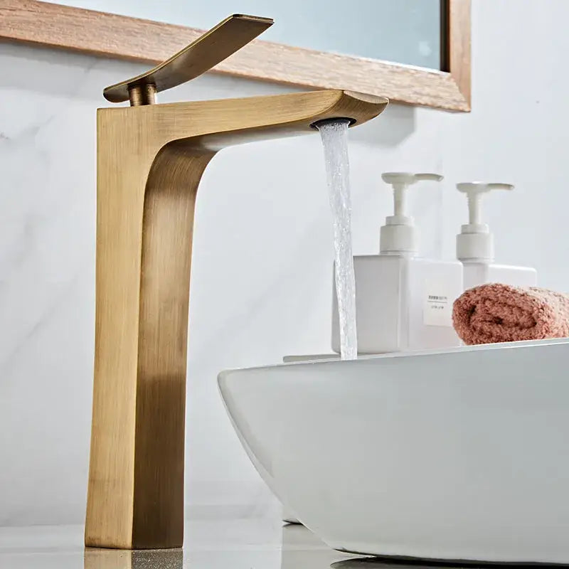 Modern bronze basin faucet with brass finish and sleek angular waterfall design for bathroom sink use by decorbites