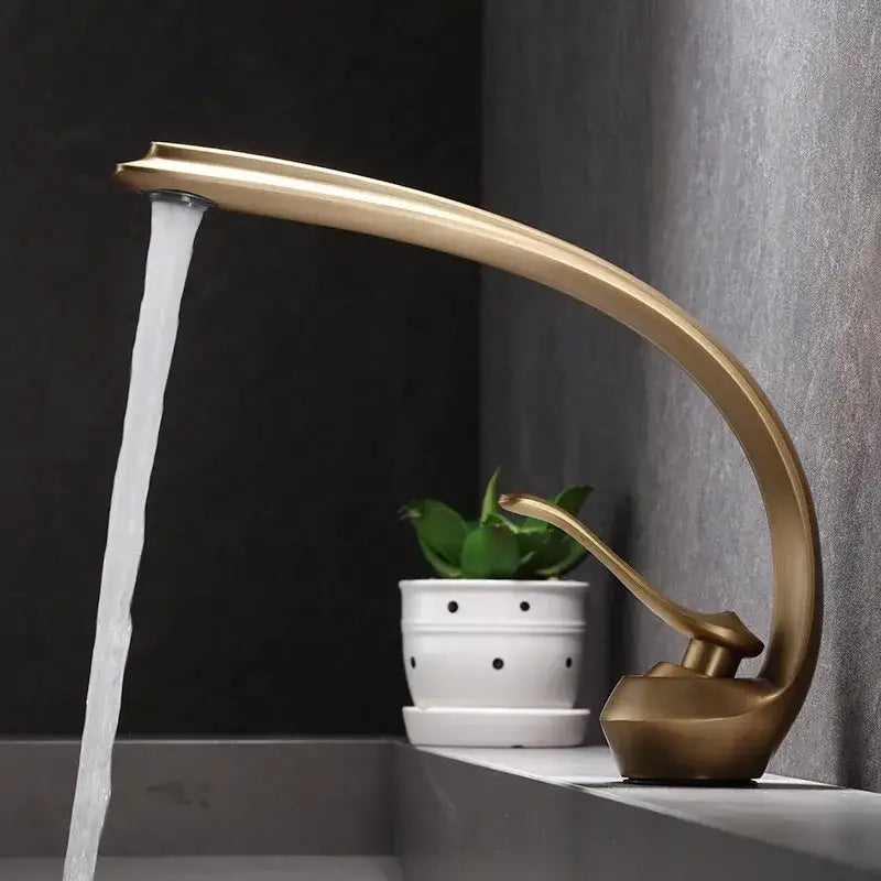 Modern bronze waterfall bathroom faucet in brass with gold-toned finish and sleek curved design flowing water stream decorbites bronze waterfall