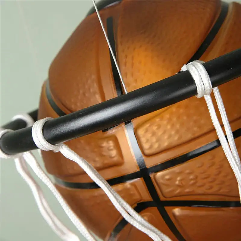 Modern brown basketball pendant lights featuring an orange textured ball in a white net hoop for kids room decorbites decor