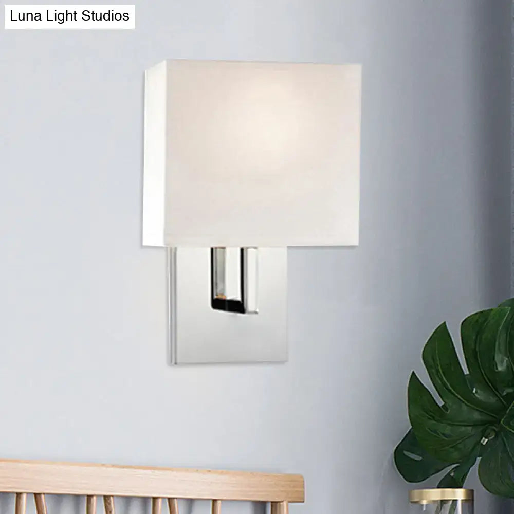 Modern brown fabric wall mount sconce with sleek chrome finish and soft off-white shade for bedroom cylinder light