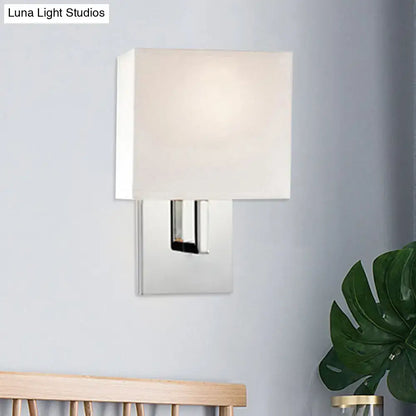 Modern brown fabric wall mount sconce with sleek chrome finish and soft off-white shade for bedroom cylinder light