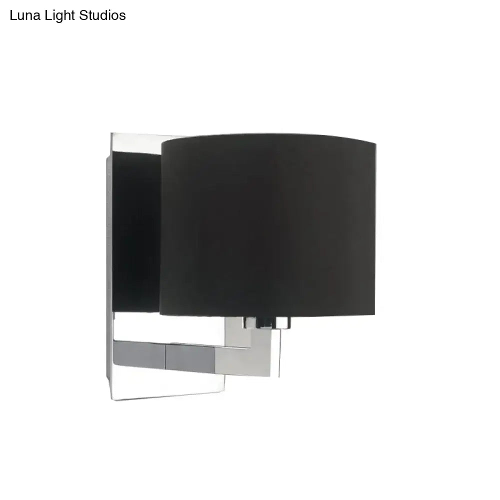 Modern black fabric wall mount sconce with sleek chrome metal frame for bedroom cylinder lighting