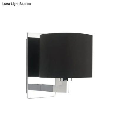 Modern black fabric wall mount sconce with sleek chrome metal frame for bedroom cylinder lighting