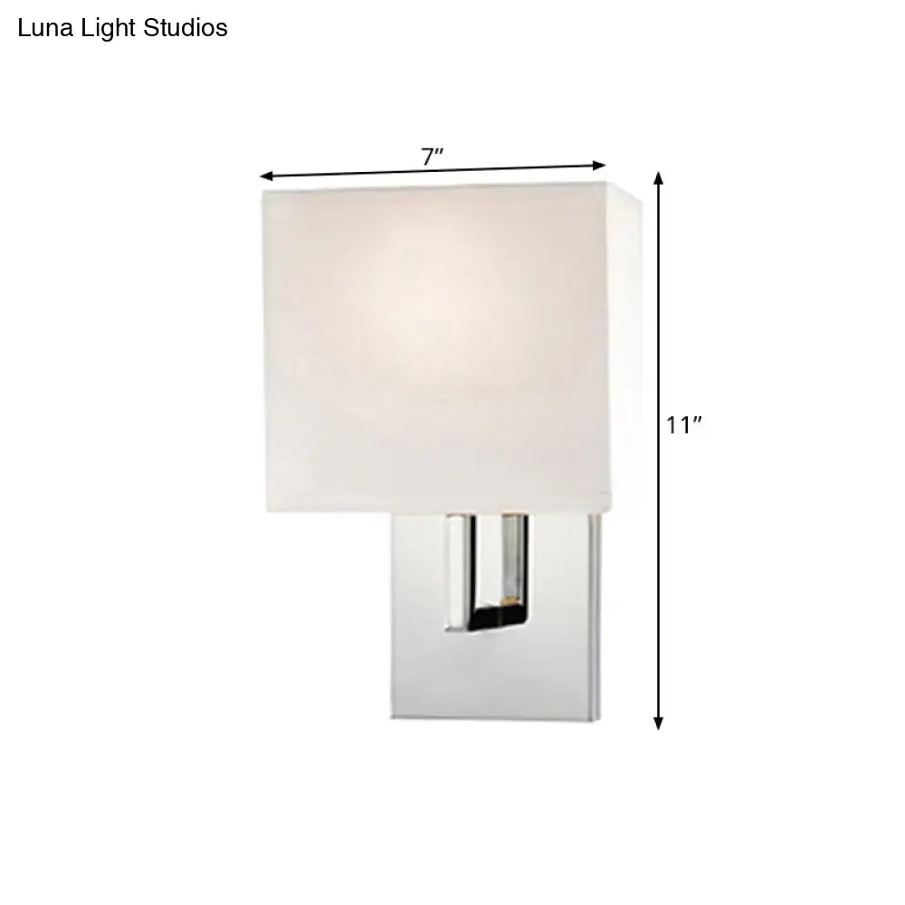 Modern chrome-finished wall mount sconce with square off-white fabric shade for bedroom lighting