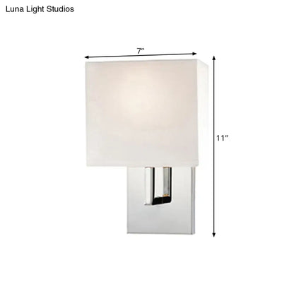 Modern chrome-finished wall mount sconce with square off-white fabric shade for bedroom lighting