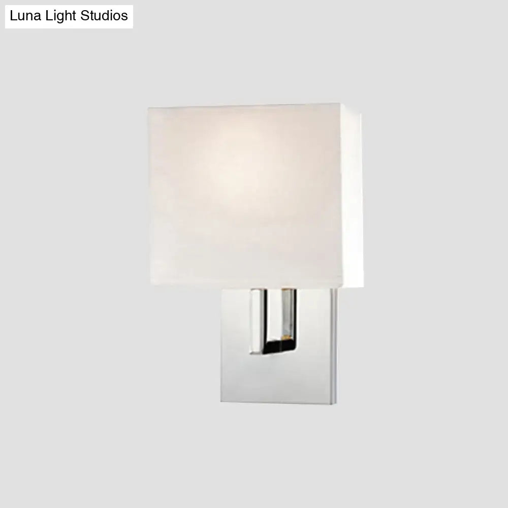 Modern wall mount square-shaped sconce with sleek chrome finish and off-white fabric shade for bedroom lighting