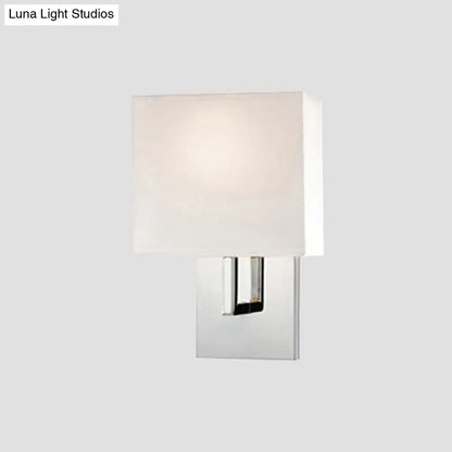 Modern wall mount square-shaped sconce with sleek chrome finish and off-white fabric shade for bedroom lighting