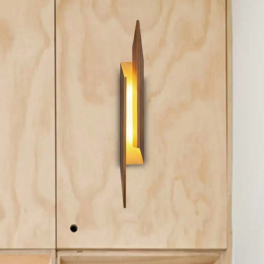 Modern brown geometric metal shade wall sconce with warm golden glow crafted from metal and wood for living room light