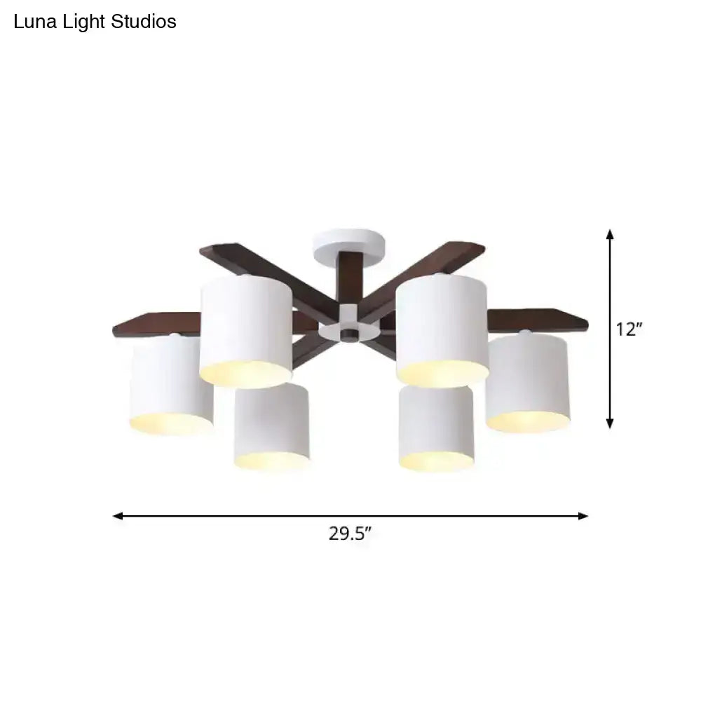 Modern brown and white ceiling mount chandelier with six cylindrical shades and dark wood arms for living room lighting