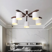 Modern brown and white ceiling mount chandelier with dark wood arms and white cylindrical shades for living room use