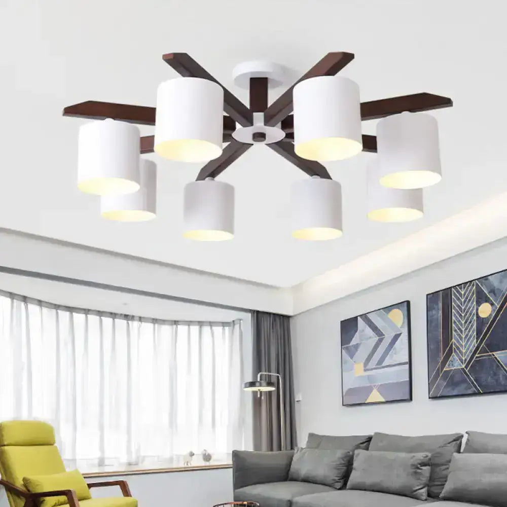 Modern brown and white ceiling mount chandelier with dark wood arms and white cylindrical shades for living room lighting