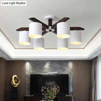 Modern brown and white ceiling mount chandelier with five white cylindrical shades and dark wood arms for living room use