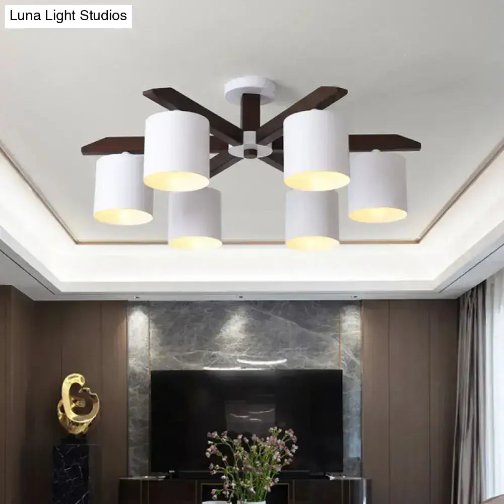 Modern brown and white ceiling mount chandelier with five white cylindrical shades and dark wood arms for living room use